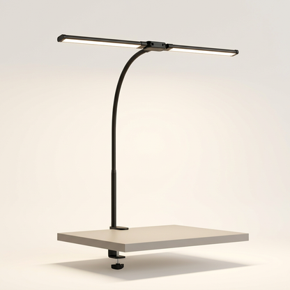 Dual-head LED clamp desk lamp on a neutral background